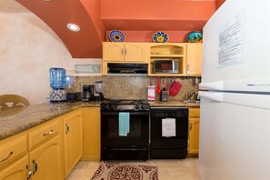 A compact kitchen with a stove, oven, microwave, and a refrigerator. - Charming, Cozy Condo Great View Pinacate 404 (Puerto Peñasco)
