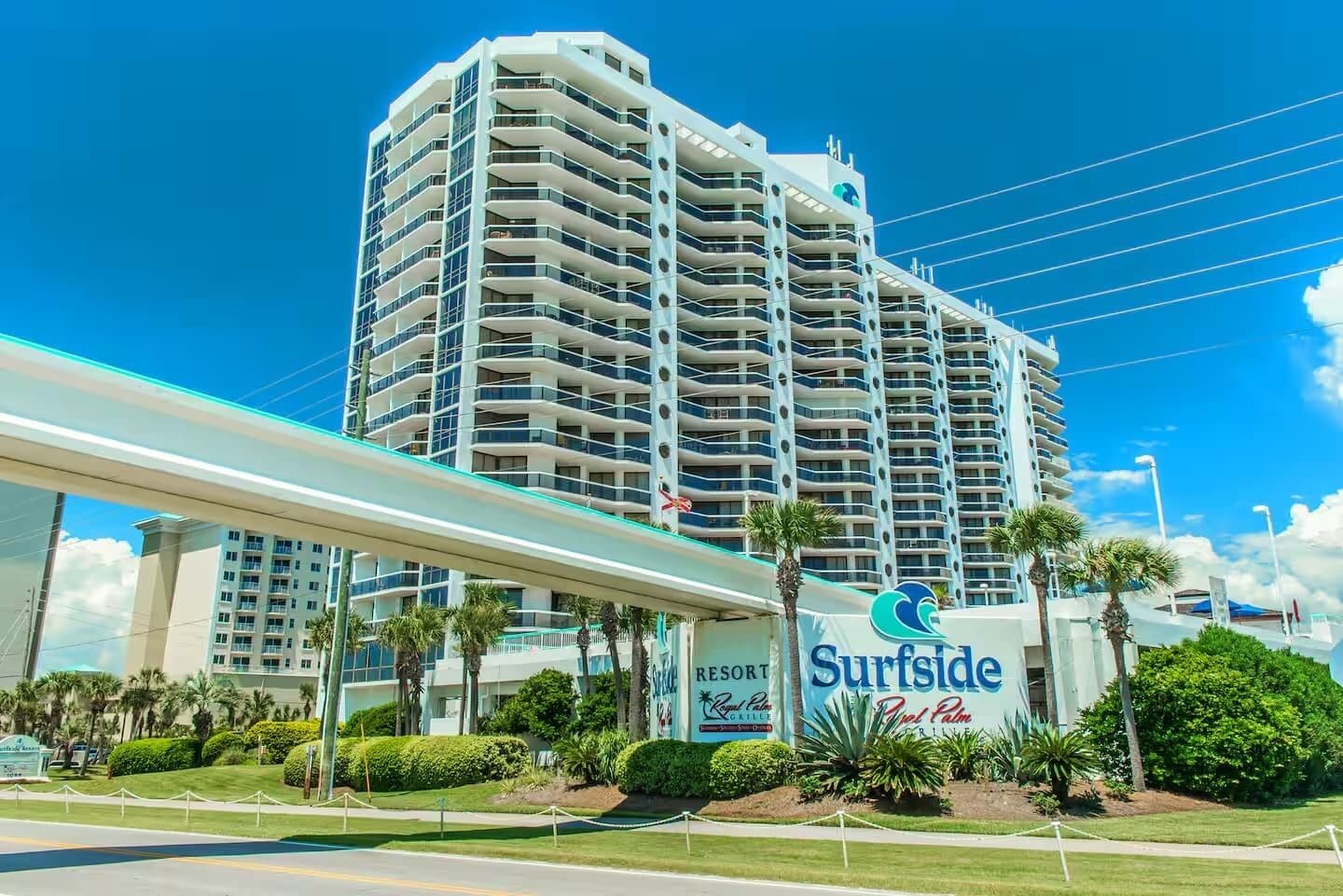 A high-rise hotel with a prominent 'Surfside Resort' sign, multiple balconies, and a covered walkway.