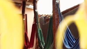 A covered outdoor area with hammocks hanging between wooden posts. - Pousada Árvore da Vida (Bonito)