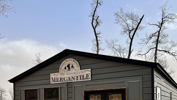 A building labeled 'The Mercantile' with a sign indicating it's a handmade market and retreat. - Cozy Two Loft Tiny House Cabin near beautiful Roaring River with AC (Cassville)