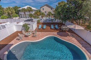 A swimming pool with lounge chairs and a deck area. - Destiny Awaits | 6BR | Gulf View! Private Pool & Golf Cart! Walk to Beach! (Destin)