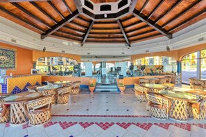 An open-air restaurant with a high ceiling, tiled floor, and wicker furniture. - Stunning Views in 2nd Level Condo Princesa B-203 (Puerto Peñasco)