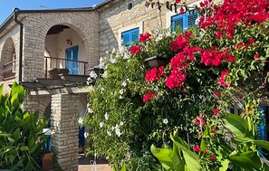 A stone building with a balcony, a door, and a window with blue shutters. - Stunning home in Liznjan (Liznjan)