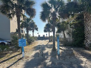 A parking area with a sign indicating payment options and a gate labeled 'ACCESS SPRING.'