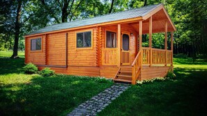 A wooden cabin with a porch, a window, and a door. - Family Cabin in the heart of The Pennsylvania Grand Canyon (Wellsboro)