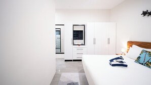 A modern hotel room with a bed, a wardrobe, a desk, and a mirror. - Solana Apartments  (Nadi)