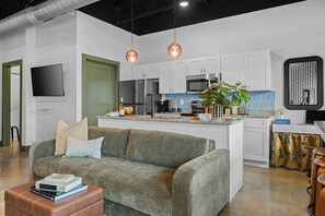 A modern kitchen with white cabinets, stainless steel appliances, and pendant lighting. - Modern 1BR Near BNA Airport & Downtown Nashville (Nashville)