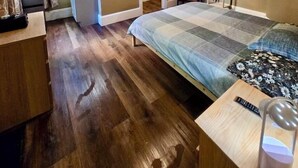 A bedroom with a bed, a desk, a chair, a lamp, and a window with curtains. - Nice large room in Federal Hill (Providence)