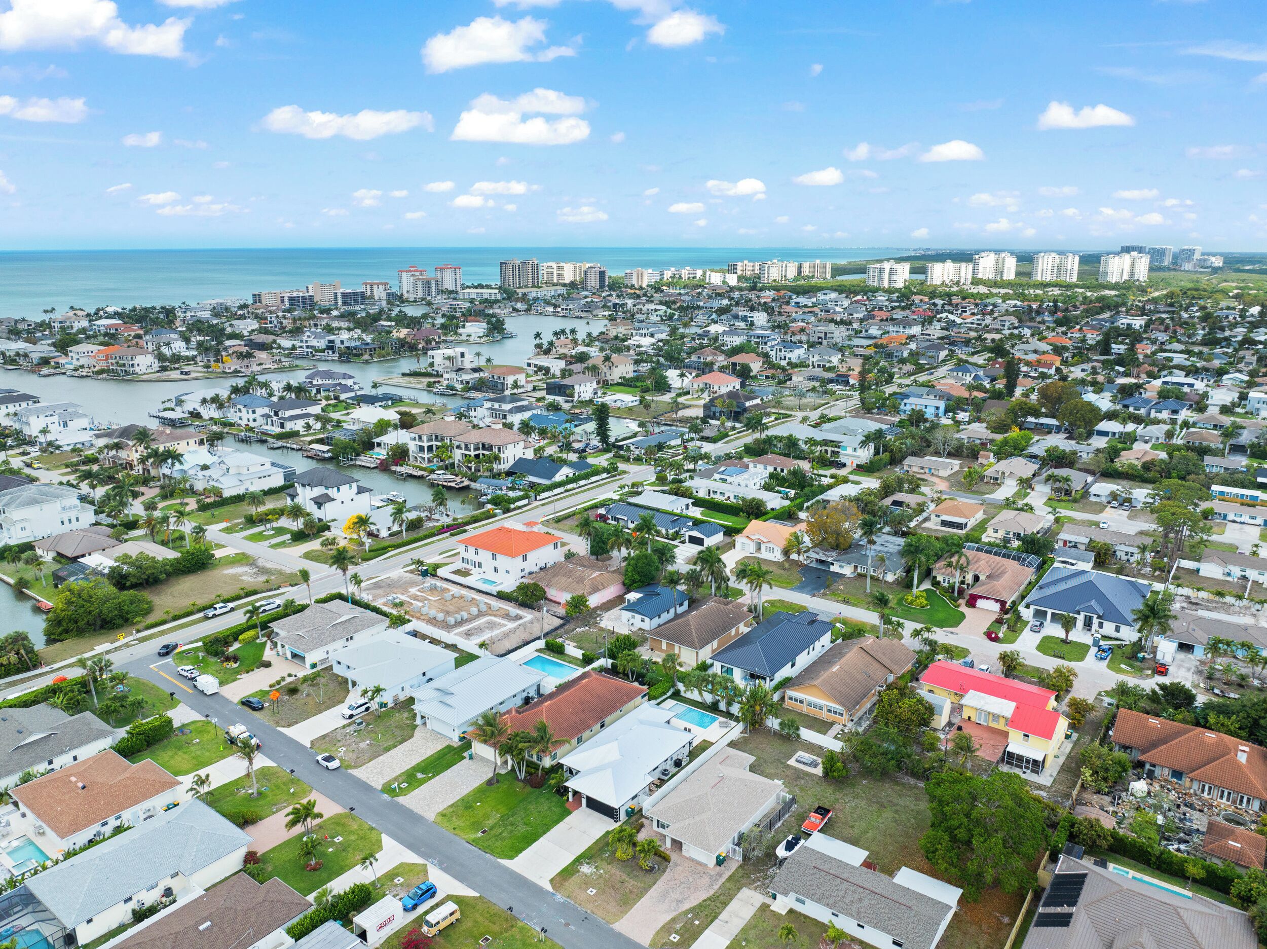 A residential area with houses, a marina, and a view of the ocean.