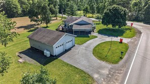 A residential property with a detached house, a garage, and a well-maintained lawn.