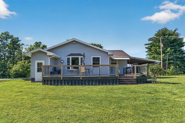 A single-story house with a front deck, a garage, and a small porch.