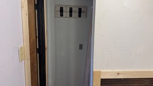 A hallway with a wooden door frame, a light switch, and a wall-mounted electrical outlet.