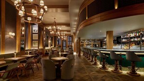 A bar area with multiple seating options and a well-stocked liquor shelf. - Vail Village Location, 5 Star Services & Amenities + Ski In/Out Base Camp (Vail)