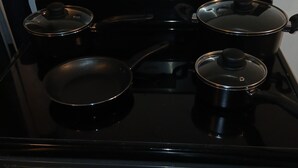 A Whirlpool gas stove with four burners, a digital clock, and a control panel.