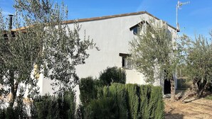 A modern building with a flat roof, a satellite dish, and a chimney.