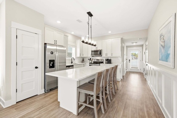 Kitchen: Modern appliances, sleek finishes, and a breakfast bar for easy meal prep and casual dining.