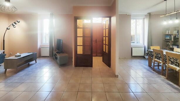 A spacious living area with a television, a desk, and a dining table with chairs. - Beautiful home in Cessenon sur Orb with WiFi (Cessenon sur Orb)