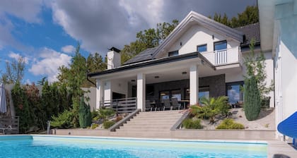 Modern villa with indoor and outdoor pool, sauna and scenic views