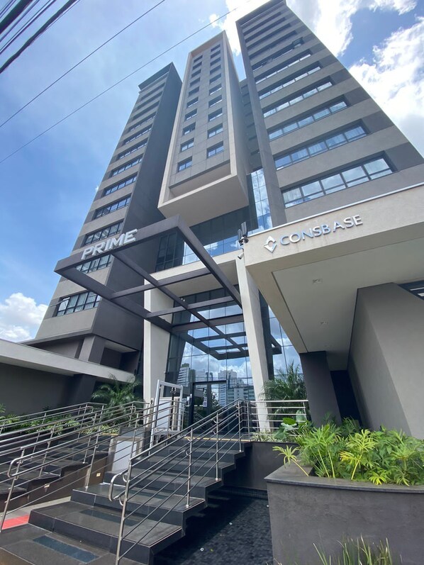 A modern building with two prominent signs, one for 'PRIME' and another for 'CONBASE'.