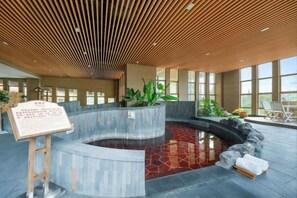 A spa area with a hot tub, wooden ceiling, and large windows. - Lutang Hot Spring Resort (Mianzhu)