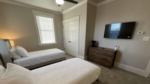 A bedroom with two beds, a dresser, a TV, and a window with blinds. - Fresh & Welcoming in the Rolling Kentucky Hills (Versailles)