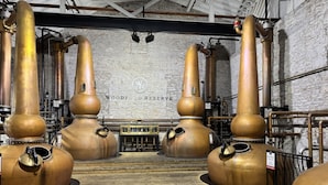 A distillery with large copper stills and a wooden floor. - Fresh & Welcoming in the Rolling Kentucky Hills (Versailles)