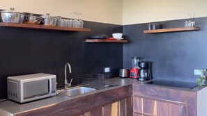 A kitchen with a microwave, sink, toaster, and a coffee maker. - Penthouse Studio with Private Jacuzzi & Sunset Views in La Veleta, Tulum (Tulum)