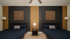 A hotel room with two beds, a nightstand with a lamp, and decorative wall panels. - Family & Group Retreat|3 Queens Beds Pool Table 11 (Birmingham)