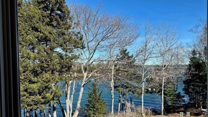 A view of a lake with trees and a wooden dock extending into the water. - Oceanfront Escape on Lish’s Cove – Private Dock & Sunrise Views (Harpswell)