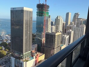 A high-rise building with a visible 'SKYX' sign, a construction crane, and a Ferris wheel in the background. - High Floor 3-Bdr Apartment with Incredible Views, Pool & 24/7 Gym G4416 (Miami)