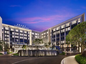 A modern hotel with a prominent sign reading 'Garden Resort,' featuring a multi-story structure with a water feature in front. - Garden Resort Kunming Changshui Airport (Kunming)