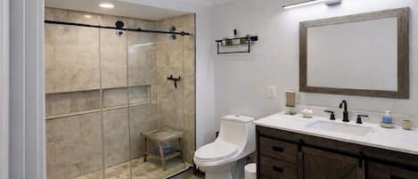 Shower, hair dryer, towels, shampoo