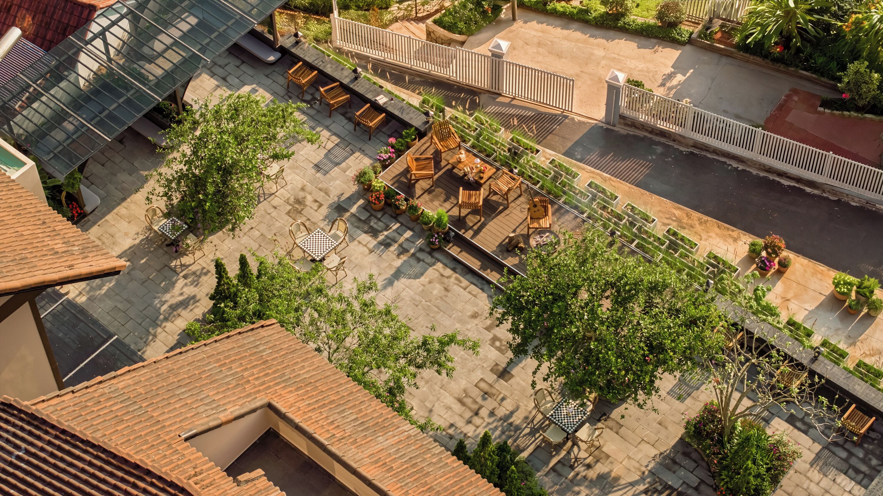An aerial view of a courtyard with a patio, seating areas, and potted plants.