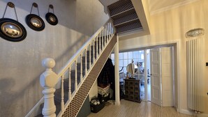A staircase with a white balustrade and a patterned wall.