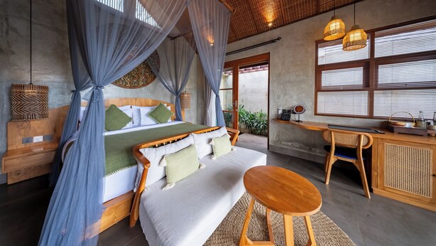 A bedroom with a bed, bedside table, and a desk with a chair. - ULU Valley Retreat  (Sebatu)