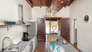 A kitchen with a stainless steel sink, a coffee maker, and a breakfast setup with fruit and a glass of orange juice. - Villa VILLA MARIJANA 6+0 (Srima)