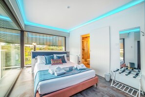 A modern bedroom with a large bed, a walk-in closet, and a view through the window. - 7br Luxury Villa - Pool, Garden & Parking, Scorrano, Italy (Scorrano)