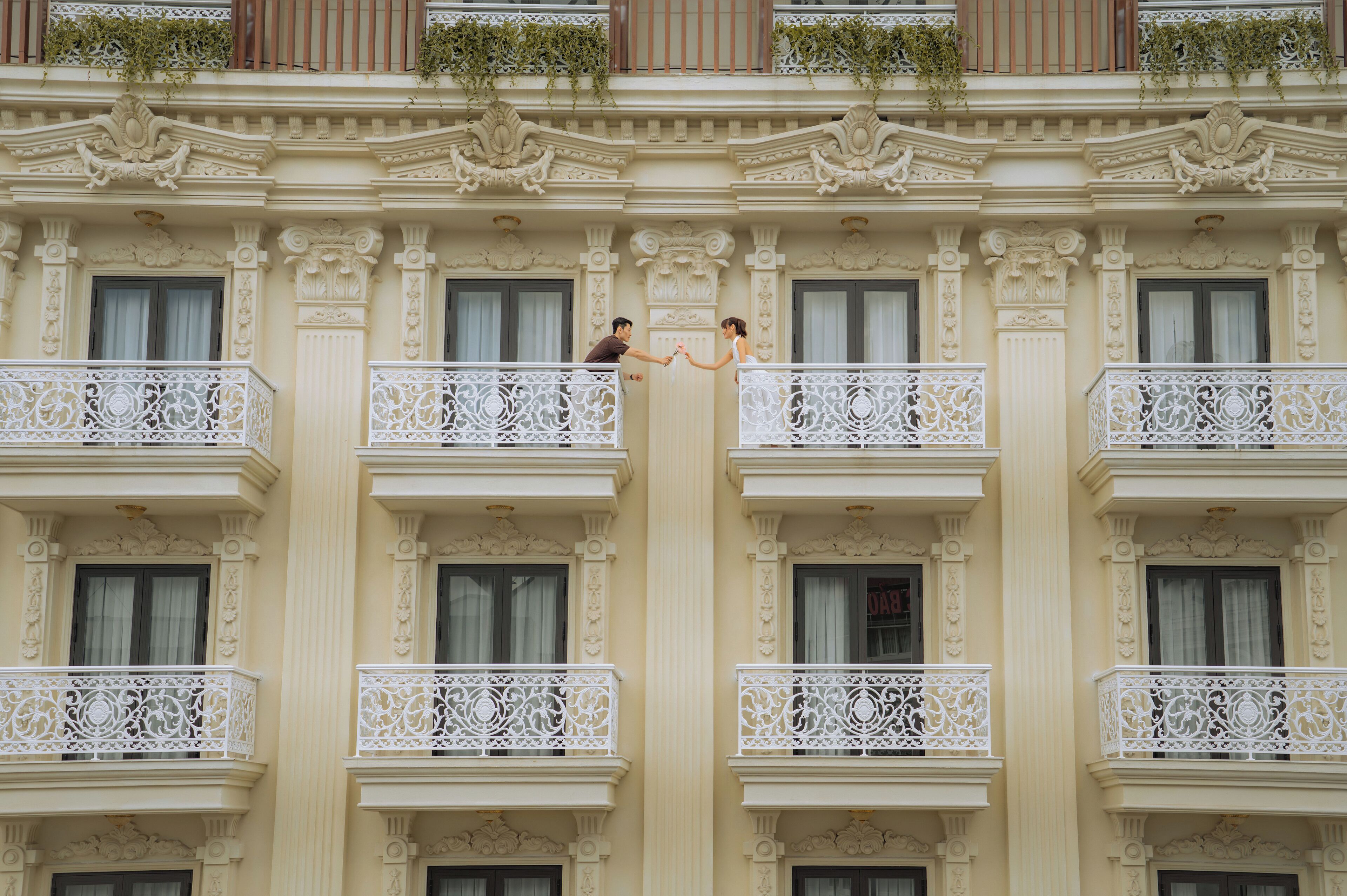 A building with ornate balconies and decorative moldings.