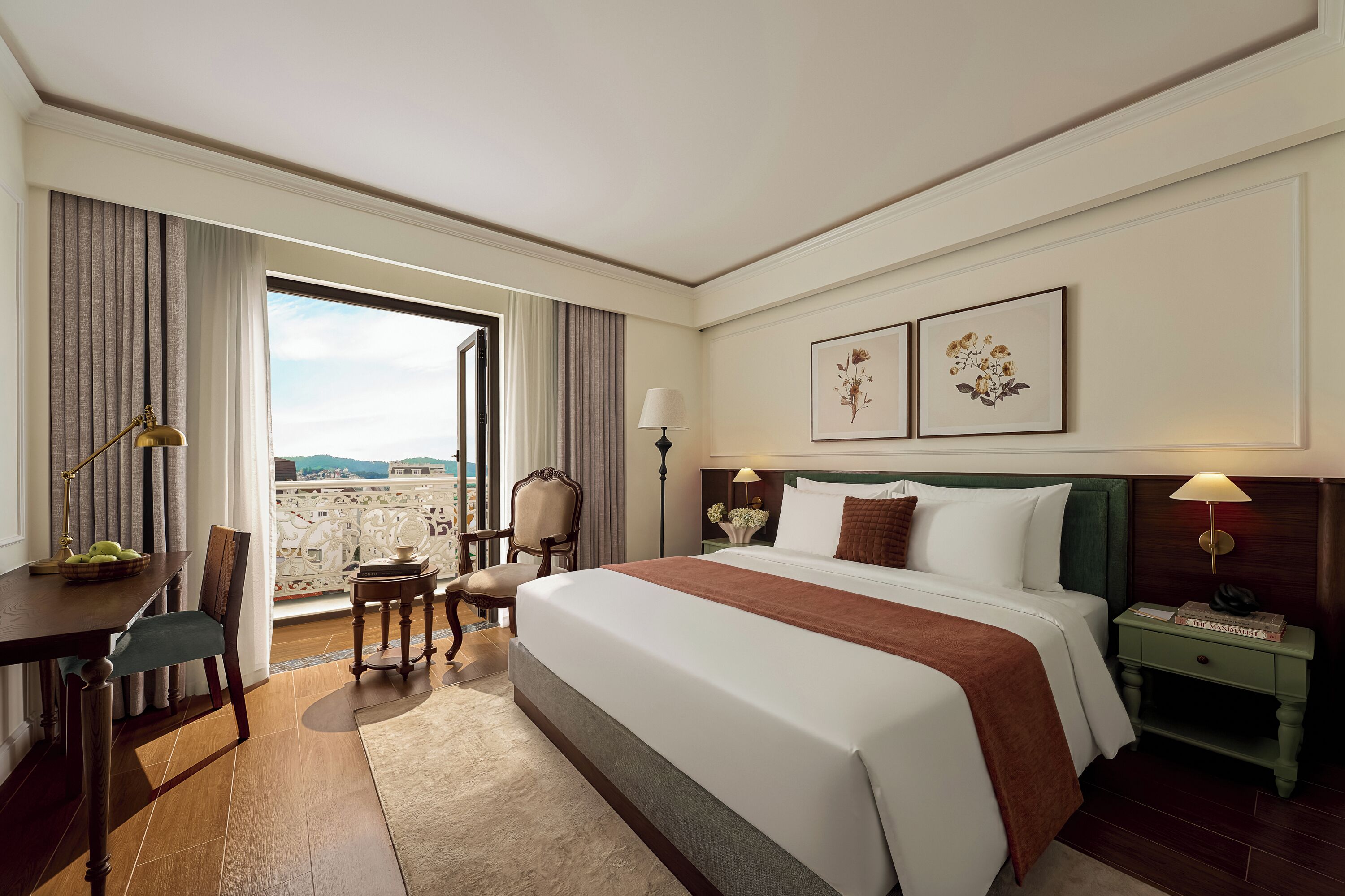 A hotel room with a bed, a desk, a chair, a nightstand, and a view of the outdoors.
