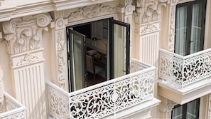 A building with ornate white balconies and intricate architectural details.