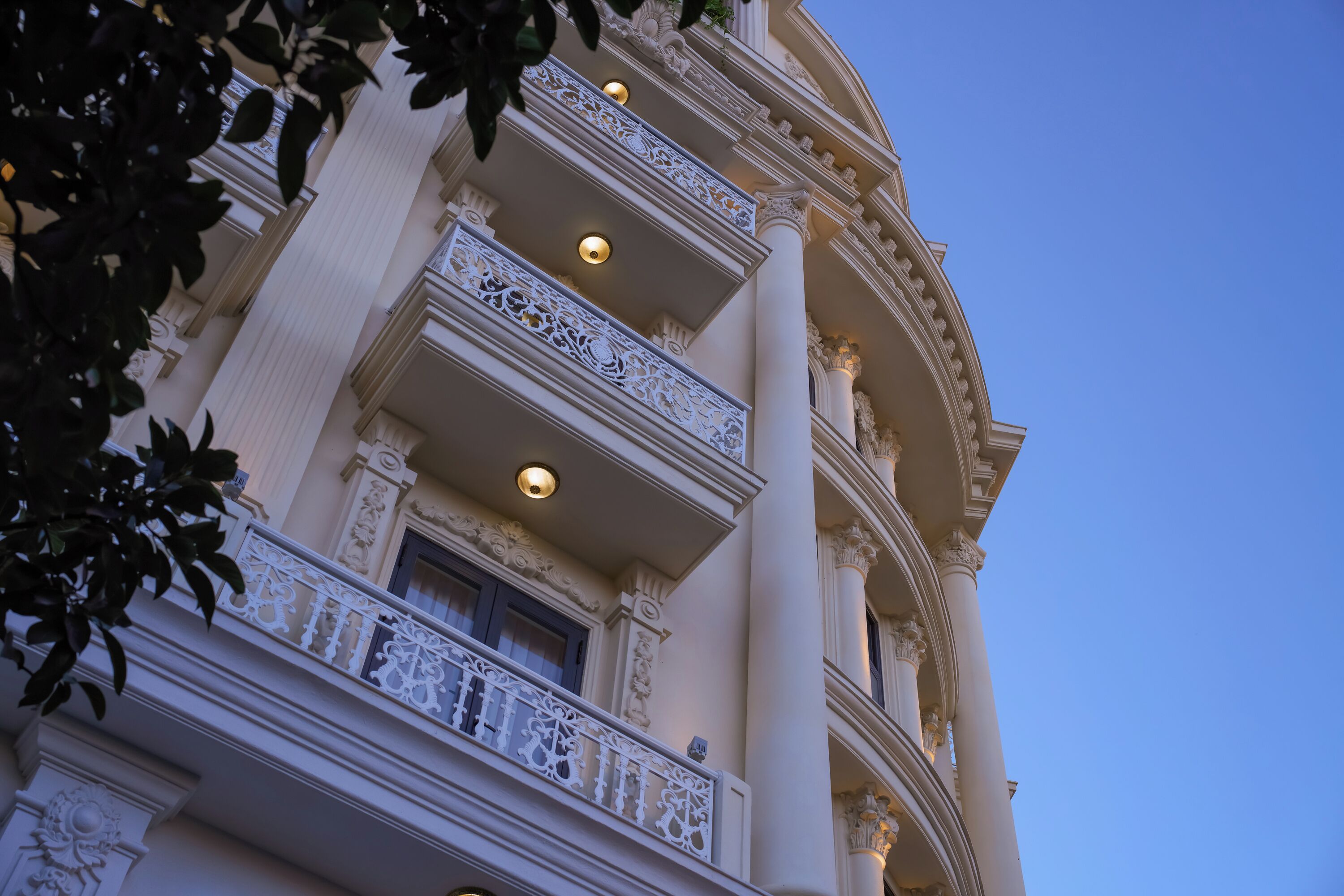 A multi-story building with ornate balconies and classical architectural details.