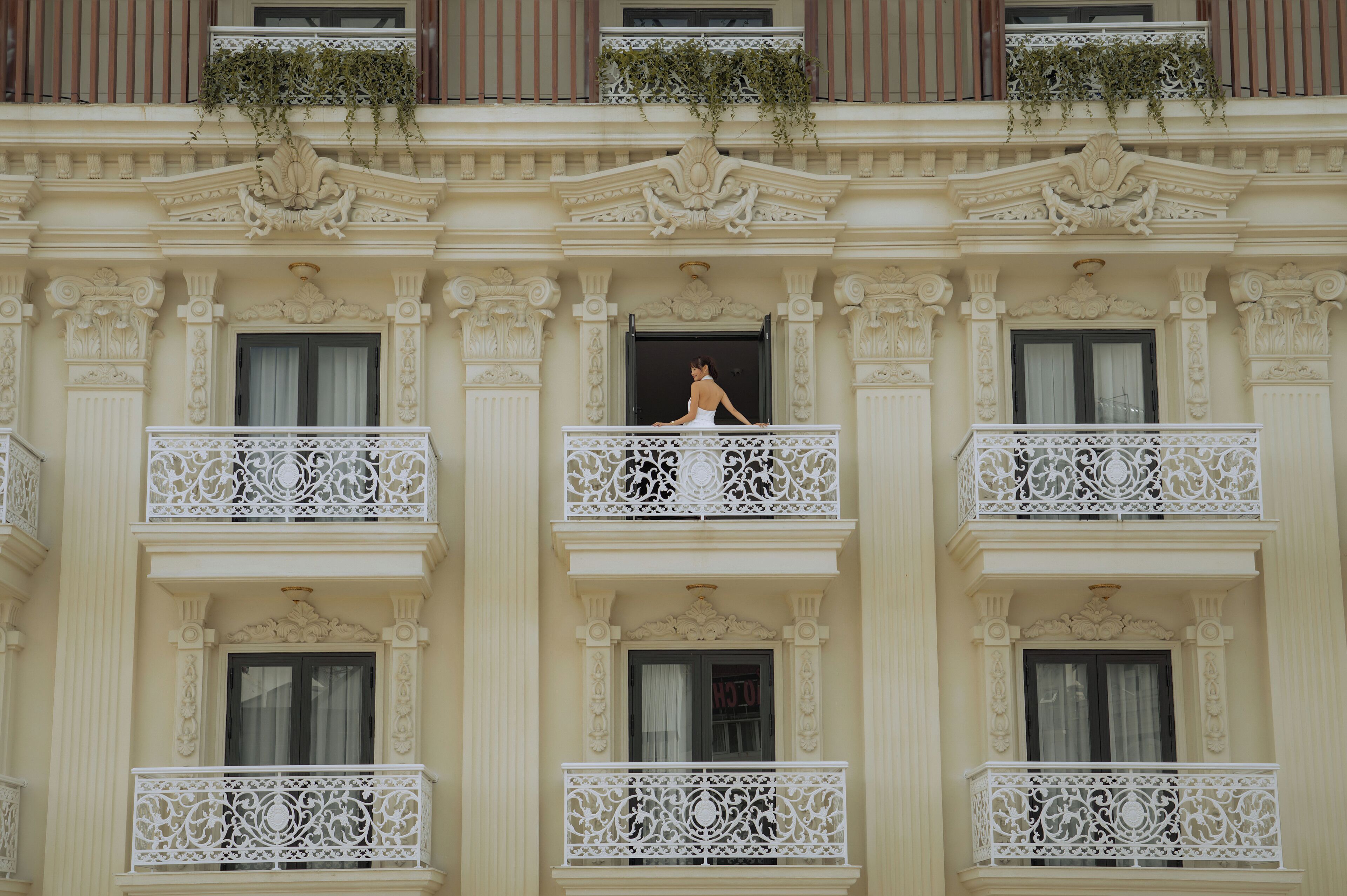 A building with ornate balconies and a central entrance.