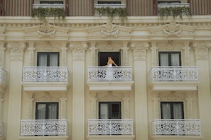 Un edificio con balcones decorativos y una entrada central.