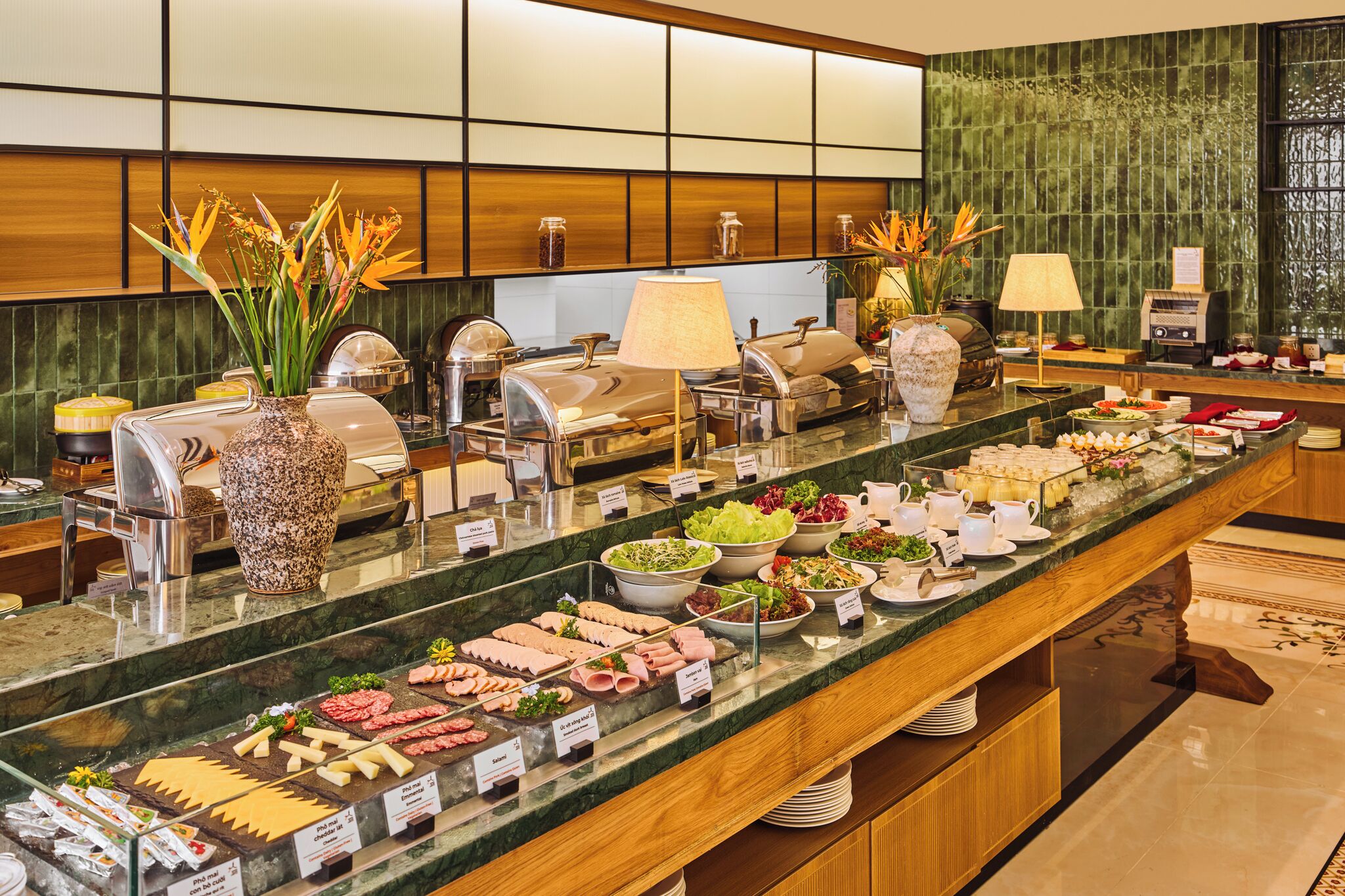 A buffet with various food items and a decorative vase.