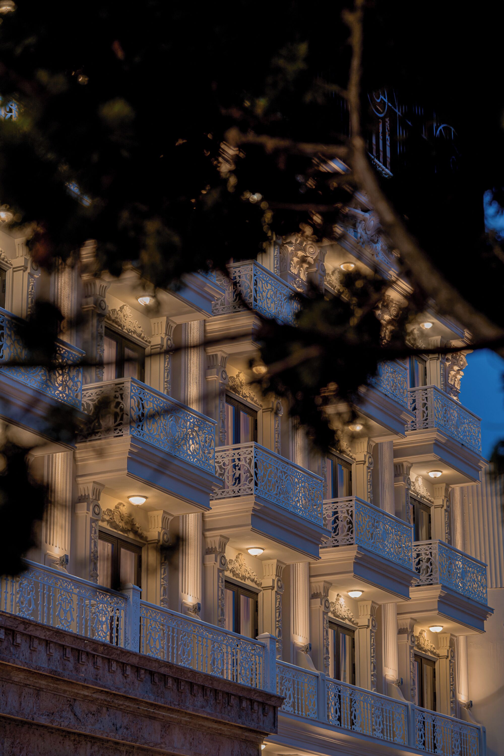 A multi-story building with ornate balconies and classical architectural details.