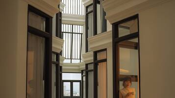 A multi-level interior corridor with multiple windows and a central open space.
