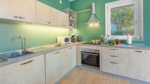 A modern kitchen with a built-in oven, a microwave, and a sink. - Appartamento Girasole with Terrace, Torino, Italy (Torino)