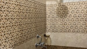 A bathroom with a white sink, a shower, and a toilet. - Tremendous 1-bedroom house in vibrant Bengaluru awaits you (Bengaluru)