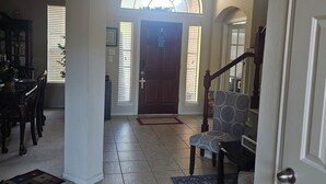 A spacious foyer with a high ceiling, a grand staircase, and a large arched window. - Fresh Baked Cookies /Brownies with  check in from Sweet Vegan Cookie Company (Mesquite)