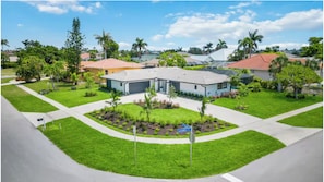 A residential area with houses, a well-maintained lawn, and a sign indicating 'Loyalty Ave.'